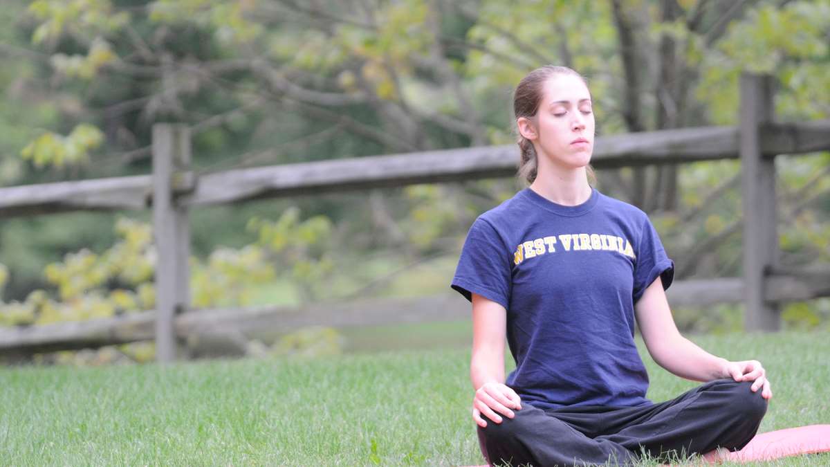 A WVU student meditating at a WELL WVU event