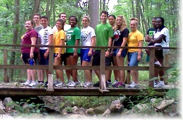HCOP Members standing on a bridge in the woods