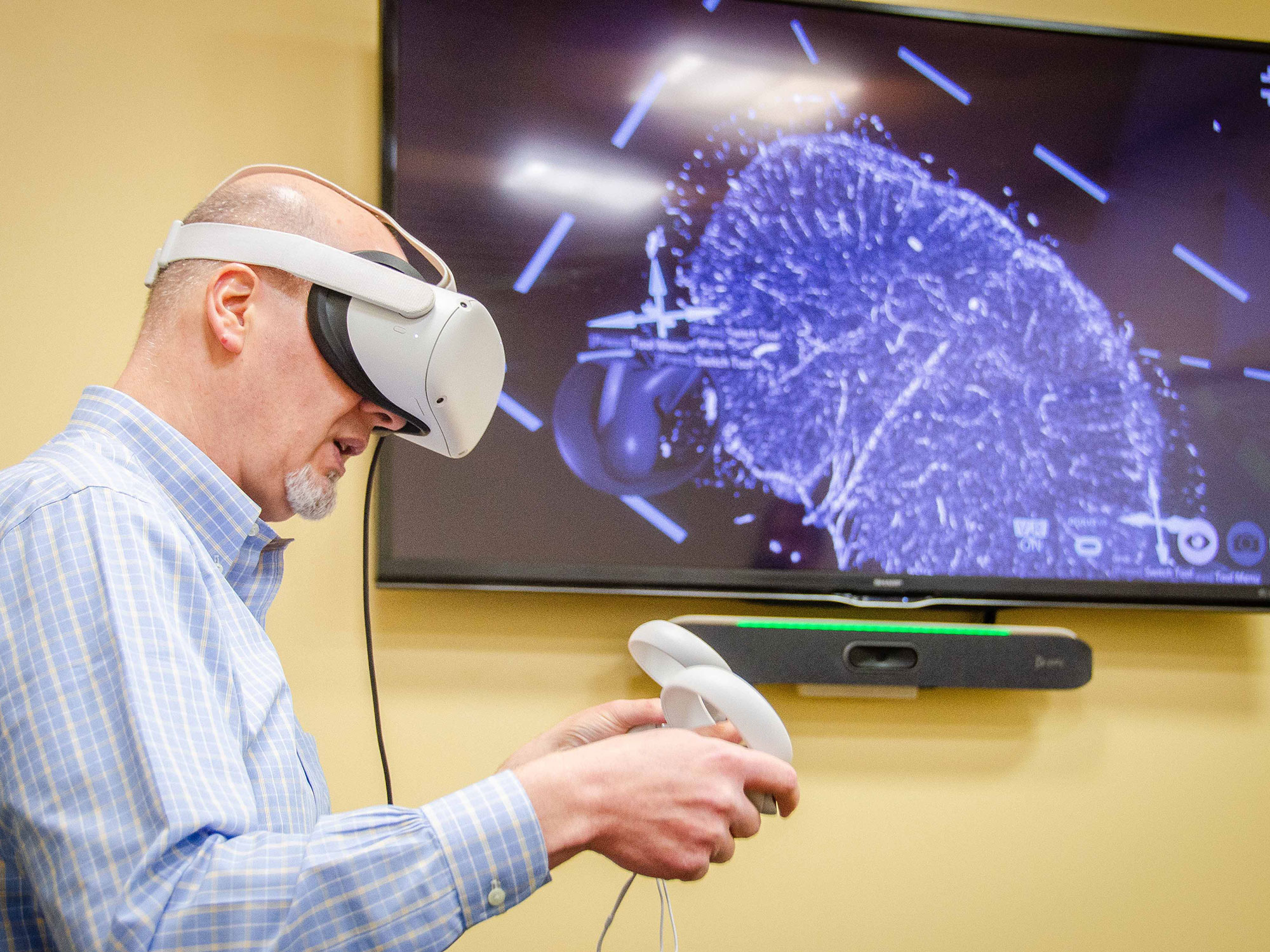Students with clip boards taking notes at a poster presentation.